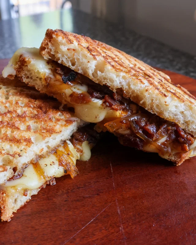 Savour the savoury-sweet goodness of our Bacon and Brie Panini .Featuring the same beloved house-made bacon jam from our smoked brisket sandwich at @academyhillgrill, paired with creamy brie on your choice of Ste. Annes Bakery gluten-free bread. Comfort food at its finest! Open daily - come see us for lunch!#GlutenFreeEats #BaconBrieLove #SteAnnesBakery